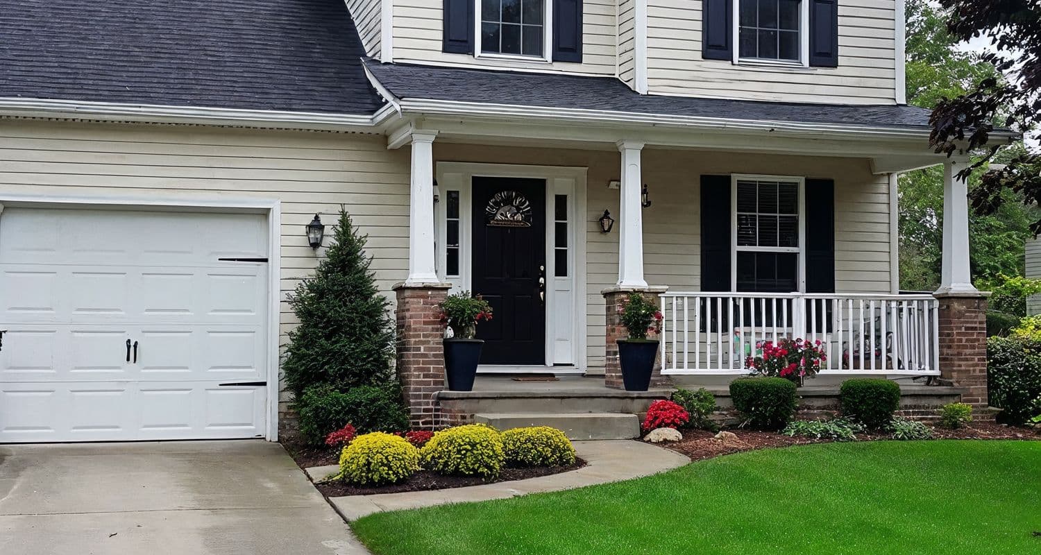 A suburban house exterior with garage and front lawn